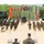 U.S., Indian Army leaders address Yudh Abhyas 2026 formation A joint military ceremony or parade is taking place on an open sandy ground, with two formations of soldiers standing at attention on either side of a central aisle. Two senior officers — one in Indian Army camouflage and one in US Army MultiCam uniform with the name tape 'BUCKLEY' — are observing from an elevated platform. Flags of India and the United States are prominently displayed, along with a ceremonial backdrop banner suggesting a bilateral military exercise.