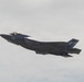 A U.S. Marine Corps F-35B stealth fighter jet is captured in flight against an overcast sky. The aircraft belongs to VMFA-533 (Marine Fighter Attack Squadron 533) as indicated by markings on the fuselage. The jet appears to be in level flight, possibly during an airshow or training exercise.