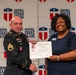 A U.S. Army soldier in dress uniform and a civilian woman jointly hold a Certificate of Completion from Central Texas College's 'What's Next' program. The certificate is presented to an individual named Brian Hoskins. Both individuals are smiling and posing in front of a Central Texas College branded backdrop.