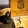 The image depicts a collection of U.S. Navy Chief Petty Officer pinning ceremony memorabilia arranged on a carpeted surface. Items include a Chief Petty Officer combination cover (hat), engraved wooden plaques and keepsakes bearing the USN anchor insignia, and a program booklet from Naval Base Kitsap. The wooden box in the background is engraved with '16 September 202_ Class 133,' indicating this is from a Chief Petty Officer pinning ceremony.