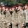 US and Japan Showcase Strong Partnership at Orient Shield 2026 Opening Ceremony A large formation of U.S. Army soldiers wearing maroon berets and MultiCam (OCP) camouflage uniforms are rendering a salute in unison during a formal military ceremony. The soldiers display various patches including Airborne and Ranger tabs visible on the foreground soldier's left shoulder. The setting appears to be an outdoor parade field with trees visible in the background.