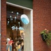 A shop window display in what appears to be a Dutch town commemorating the date 17-9-1944, which corresponds to the start of Operation Market Garden during World War II. The window features hand-painted cartoon illustrations of parachutes, a girl celebrating, and a small paratrooper figure descending. The display is artistic and celebratory in tone, likely marking an anniversary of the Allied airborne operation.