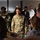 Lt. Gen. Stanton visits DISA Facility A U.S. Army soldier identified by name tape as 'STANTON' is engaged in conversation with a group of civilians in what appears to be an indoor meeting or conference setting. The soldier is wearing OCP (Operational Camouflage Pattern) uniform with 'U.S. ARMY' tape visible and rank insignia on the chest. The gathering appears to be a professional or community engagement event with a diverse group of attendees.