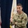 Lt. Gen. Stanton at DISA HQ. A U.S. Army officer wearing the rank of Lieutenant General (three stars) and identified by name tape as 'Stanton' is speaking at an official military event. He is dressed in Army Combat Uniform (ACU) with MultiCam pattern and displays a Ranger tab and U.S. Army shoulder patch. Multiple flags, including the U.S. flag and a military organizational flag, are visible in the background.