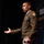 Lt. Gen. Stanton speaks at DAFITC A U.S. Army officer in Army Green Service Uniform is speaking at what appears to be a military or defense technology conference, identifiable by the 'DAVITC 2026' banner visible in the background. The officer is gesturing with an open hand, suggesting active engagement with an audience. Multiple military insignia, including a Ranger tab and shoulder patch, are visible on the uniform.