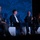Next-Generation Battle Management - AFA Panel Four panelists are seated on a stage at an AFA (Air & Space Forces Association) event, engaged in a panel discussion. One panelist is actively speaking into a microphone while the others listen. The backdrop prominently displays the AFA logo and branding in blue tones.