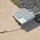 xTechAutonomy Phase II Live Demonstrations The image shows a white outdoor networking or wireless communication device branded 'Snickerdoodle' resting on a concrete surface near a gravel border. The device has multiple antennas extending from one side and a white cable connected to it with an additional antenna lying on the concrete. The equipment appears to be an outdoor-rated enclosure, likely a wireless access point or IoT gateway.