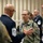 Space Force Connection Time at AFA 2026 A military gathering or conference setting where personnel from multiple branches are engaged in conversation. A bald man in a dark dress uniform with a Chief Master Sergeant insignia is speaking with a woman in U.S. Space Force camouflage uniform. The setting appears to be an indoor event with multiple uniformed personnel visible in the background.