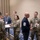 Space Force Connection Time at AFA 2026 A group of U.S. military personnel in OCP (Operational Camouflage Pattern) uniforms are gathered in what appears to be a hotel conference or event space. A civilian in a dark sweater displaying a senior enlisted rank insignia (Command Sergeant Major or Chief Master Sergeant level) is engaged in conversation with uniformed service members. The setting suggests a military symposium, conference, or professional development event.