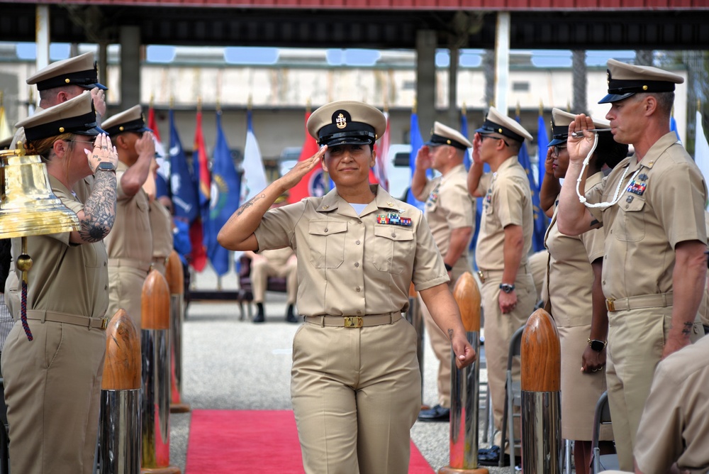 U.S. Navy Chief Petty Officer walks the sideboy gauntlet during a chief pinning ceremony