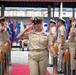 U.S. Navy Chief Petty Officer walks the sideboy gauntlet during a chief pinning ceremony