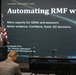 A presenter identified as Dan Daniels, Ph.D., ISO and Director of Cybersecurity at a Chief Information Office, is delivering a talk at TechNet Orlando 2026 hosted by AFCEA. The presentation is titled 'Automating RMF with A[I]' and focuses on improving capacity for ISSMs, assessors, and enabling faster AO decisions. An audience member is visible in the foreground seated with their back to the camera.