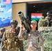 The image depicts a joint India-USA military exercise called 'Yudh Abhyas XXII' held at Auli, India, scheduled from 09-28 September 2026. Soldiers from both the U.S. Army and Indian Army are visible in full combat gear, with one U.S. soldier prominently holding a shoulder-fired rocket launcher. Both national flags and official exercise banners are displayed in the background.