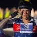A middle-aged man wearing a cycling helmet and fingerless gloves is performing a military salute at what appears to be the 30th Annual Air Force Marathon. He is wearing a race bib numbered 79 labeled 'Sky Soldiers' for the Full Marathon category, along with a patriotic red, white, and blue cycling jersey. His forearm displays a tattoo reading 'Si Vis Pacem Para Bellum' (Latin for 'If you want peace, prepare for war').