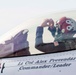 A military pilot is seated in the cockpit of a fighter jet assigned to Lt Col Alex Prevendar, Commander/Leader, as indicated by the text on the fuselage. The pilot is wearing a distinctive red and white flight helmet decorated with the Tennessee state flag design (three stars on a circle). The image is a close-up shot capturing the pilot adjusting equipment while inside the canopy-enclosed cockpit.