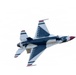 A U.S. Air Force Thunderbirds F-16 Fighting Falcon is captured in flight performing an aerobatic maneuver, viewed from below at an angle. The aircraft displays the distinctive Thunderbirds livery of red, white, and blue with the iconic thunderbird logo on the fuselage. The aircraft appears to be in a banked or inverted position against a bright, overcast white sky.